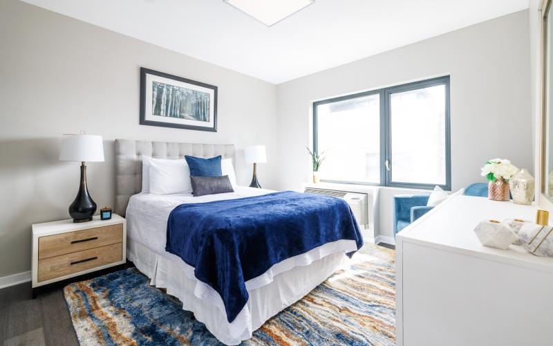 a bedroom with a bed and a window