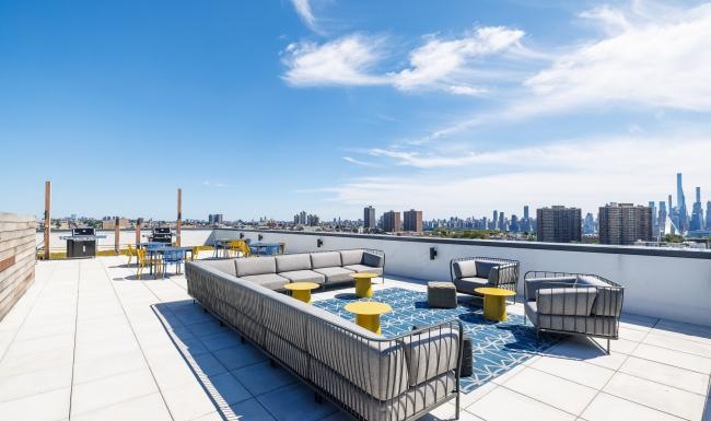 a rooftop with a city in the background