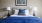 a bed with blue pillows